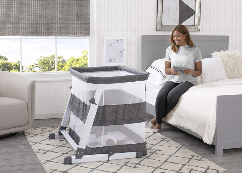 Simmons Kids Room2Grow 2-in-1 Newborn Bedside Bassinet & Infant Sleeper - Height Adjustable Portable Crib with Wheels & Airflow Mesh, Grey Tweed